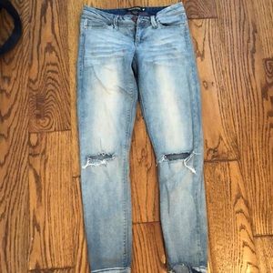 ripped at the knee light wash skinny jeans